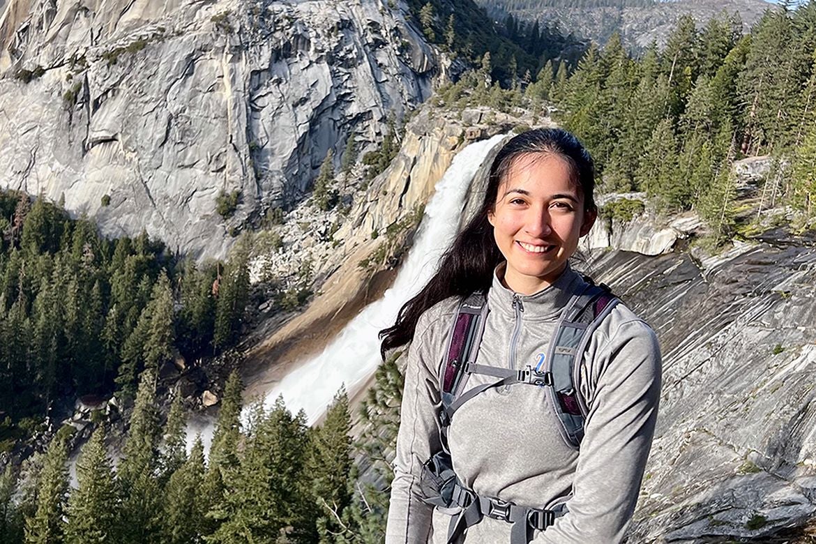 UCLA doctoral student Abijah Simon with mountains in background.