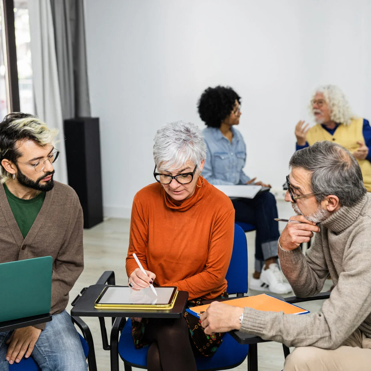 Three individuals look over a document.